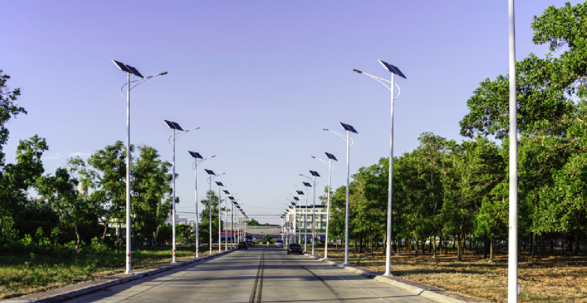 A row of integrated solar street lights illuminating a modern urban pathway